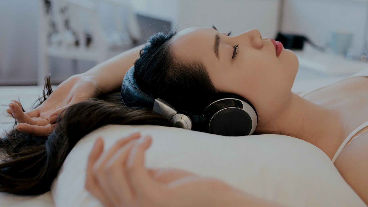 Girl with headphones listening to piano music