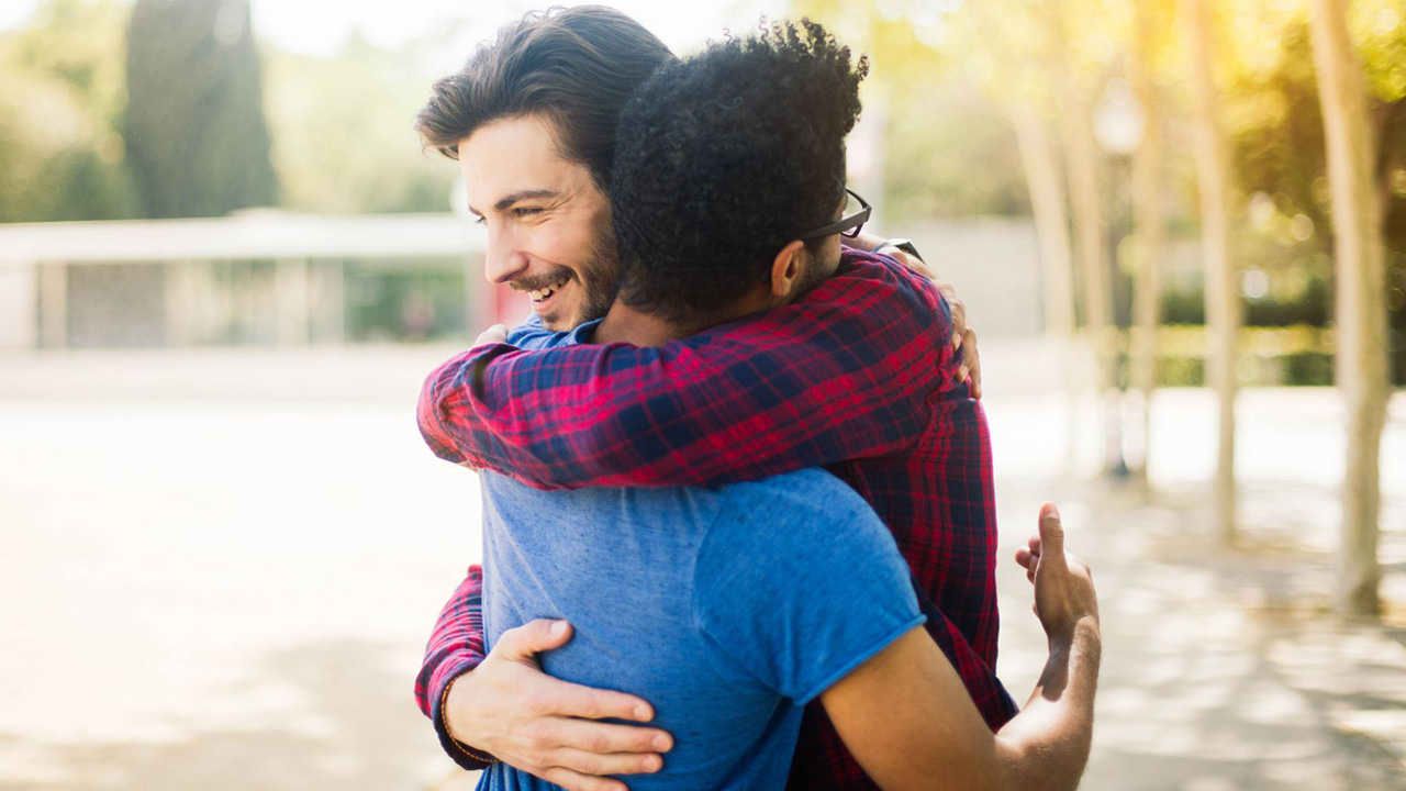 Two guys quick pat hug